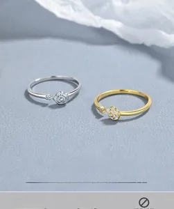 Detailed macro view of white enamel rose rings with small inset zircon in gold and silver