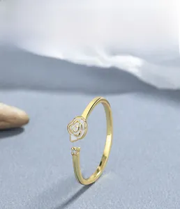 Macro detail of S925 sterling silver gold ring with white rose and zircon accent