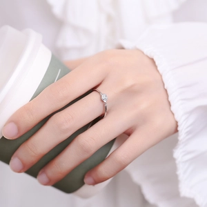 925 sterling silver open rose ring with small zircon on a model holding coffee