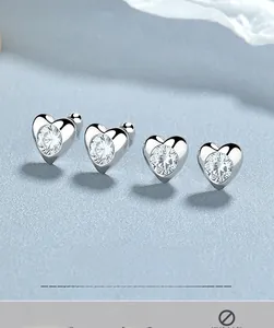 Detailed view of 925 silver heart stud earrings with round zircons and screw ball backs