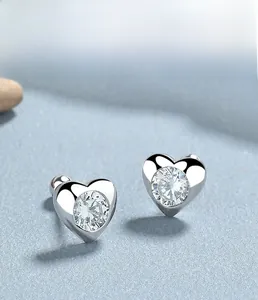 Macro shot of 925 sterling silver heart studs with bezel-set clear cubic zirconia