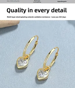Detail of 925 sterling silver heart-shaped zircon hoop earrings with gold plating finish