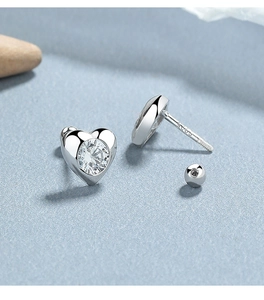 Detail of 925 sterling silver heart earrings with screw back design and cubic zirconia