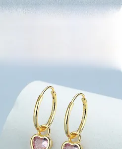 Close-up of heart-shaped pink crystal on S925 sterling silver gold-plated earring