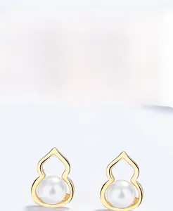 Close-up of gold-plated S925 silver gourd earrings featuring elegant white pearls