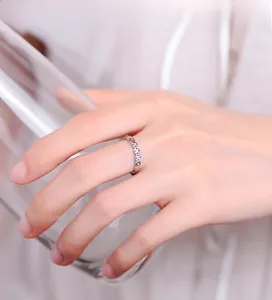 Macro detail of 925 sterling silver ring with coin patterns and small zircon stones