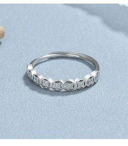 Macro shot of 925 sterling silver coin ring with sparkling zircon inlays for women