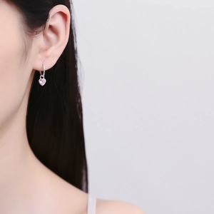 925 sterling silver hoop earrings with pink heart cubic zirconia pendant on ear