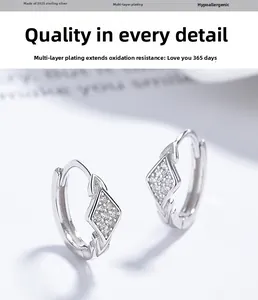 Macro shot of 925 sterling silver geometric rhombus earrings with crystal pavé setting