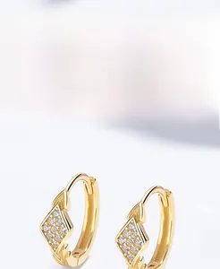 Macro view of gold S925 silver rhombic hoop earrings with sparkling cubic zirconia