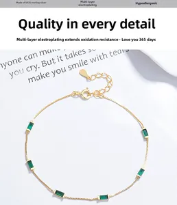 Detailed macro of S925 silver box chain with emerald green rectangular cubic zirconia