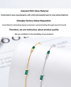 Macro shot of 925 sterling silver box chain bracelets with emerald green square stones
