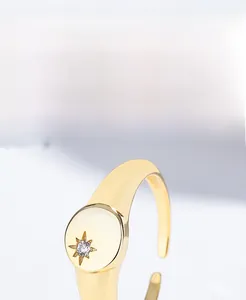Detail of adjustable S925 sterling silver starburst ring with gold plating and zircon