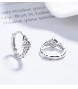 Detailed close-up of 925 silver rhombus earrings with shimmering white zircon stones