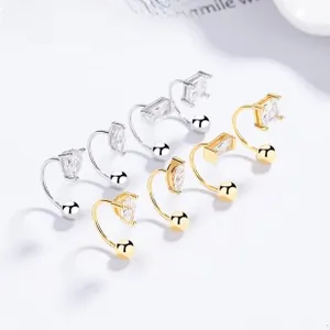Detail of 925 sterling silver U-shaped earrings with pear and square cut zircons