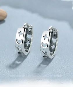 Close-up of 925 sterling silver hoop earrings with hollow star and moon design