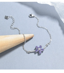 Dettaglio macro del bracciale in argento 925 con fiore in zircone viola e cuore