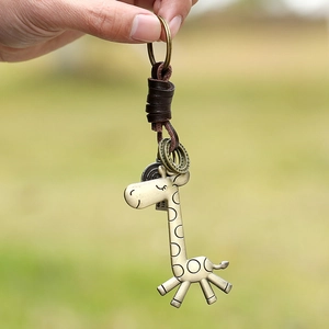 Vintage-Giraffe-Schlüsselanhänger aus Bronze mit echtem Lederband auf Außenhintergrund