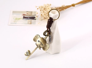 Detail of bronze elephant keychain with braided leather and engraved Love You heart tag