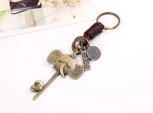 Macro detail of bronze elephant pendant with Love You heart charm and leather wrap cord