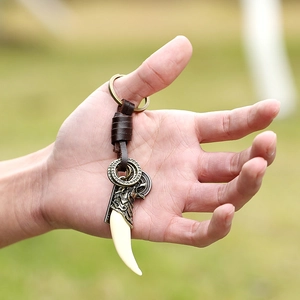 Punk leather keychain with vintage resin wolf tooth and bronze wolf head emblem