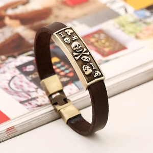 Vintage dark brown leather bracelet with an antique brass skull and crossbones metal plate