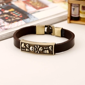 Retro brown leather bracelet with bronze skull embossed plaque and vintage metal clasp