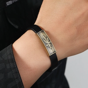 Retro black leather bracelet featuring a vintage bronze leaf-embossed metal plate