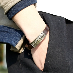 Retro brown leather bracelet with I Love You engraved metal plate worn on wrist
