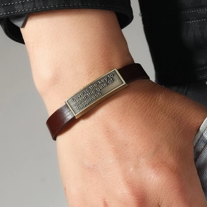 Vintage dark brown leather bracelet for men featuring a bronze plaque with engraved letters
