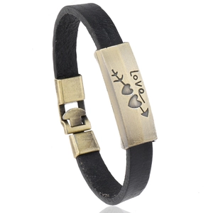 Retro black leather bracelet with bronze love heart engraving from a side angle view
