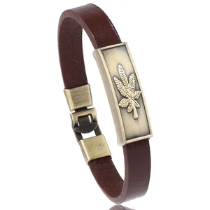 Retro brown leather bracelet for men with vintage maple leaf alloy charm on white background