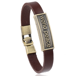 Vintage brown leather bracelet with bronze metal plate featuring world peace engraving