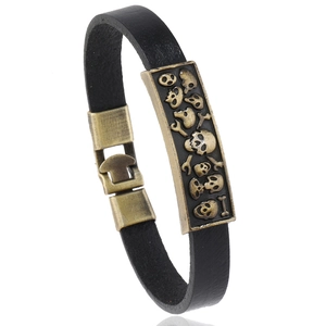 Punk vintage black leather bracelet featuring antique bronze skull relief and metal clasp