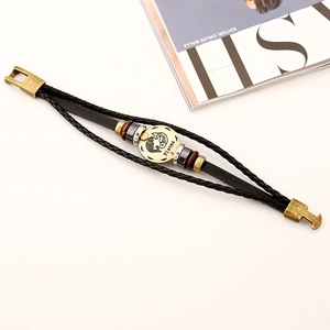 Pisces zodiac multi-layer braided leather bracelet with vintage metal plate on white desk