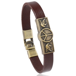 Vintage brown leather bracelet featuring embossed bronze peace sign and dove charm