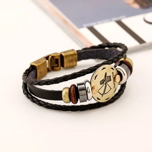 Macro shot of Sagittarius leather bracelet with braided straps and bronze zodiac charm