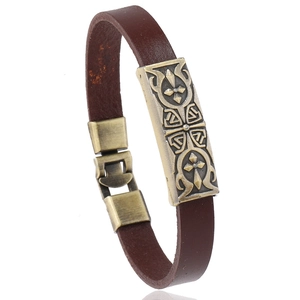 Retro punk brown leather bracelet with bronze Celtic cross metal charm on white background