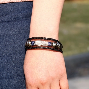 Braided black leather layered bracelet with silver wing charm and vintage metal beads