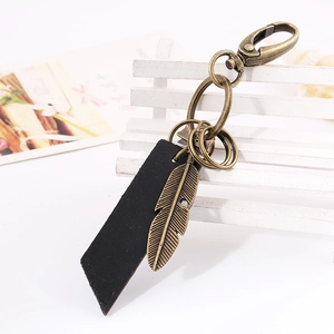 Vintage black leather keychain with bronze feather charm and rotating lobster clasp