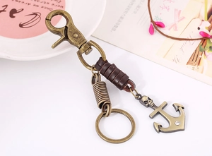 Detail of vintage bronze skull anchor pendant with leather wrap on keyring