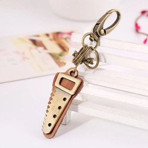 Vintage bronze saw pendant keychain with brown leather strap and lobster clasp on mini bench