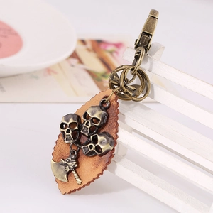Vintage punk bronze skull keychain with brown leather leaf base and metal axe pendant