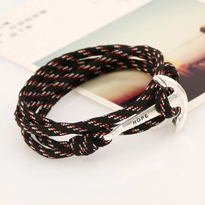 Macro shot of silver anchor clasp with HOPE engraving on a braided nautical rope bracelet