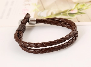 Close-up of vintage dark brown braided double-wrap leather bracelet with silver clasp