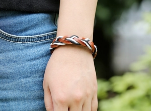 Close-up of hand-woven retro leather bracelet with brown and black braided textures