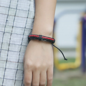 Handmade woven black leather bracelet with red stitching and adjustable cord for unisex wear