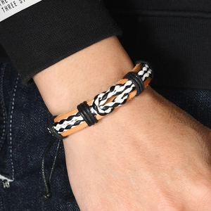 Handmade multilayer braided leather bracelet with adjustable cord worn on a wrist