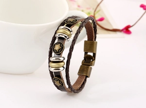 Close-up of vintage multi-layer brown leather bracelet with star charms and bronze clasp