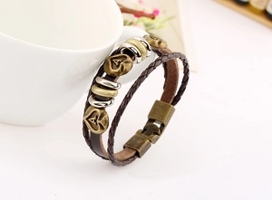 Detail of multi-layer braided leather bracelet with heart charms and metal letter A